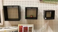 Set of three-dimensional wall shelves. Each can be