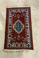 Small Persian rug styled chair rug measures 34x20
