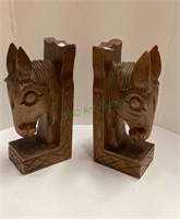 Carved wood horse head bookends each measures 8