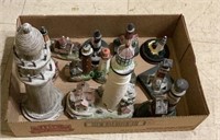 Box of small lighthouse figurines. 636