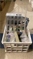Large plastic crate full of office supplies
