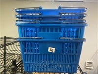 Five blue plastic shopping baskets with wire