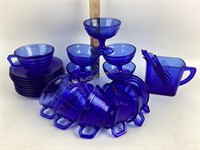 Cobalt glass mugs (7), saucers (11), footed bowls
