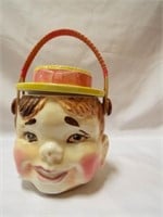 Vintage boys face with hat and wicker handle