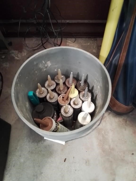 Yellow 5 gallon bucket full of caulk