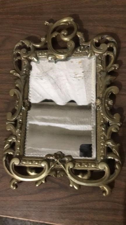 Ornate heavy brass tone mirror with beveled