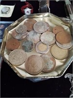 Group of foreign coins on a candy tin