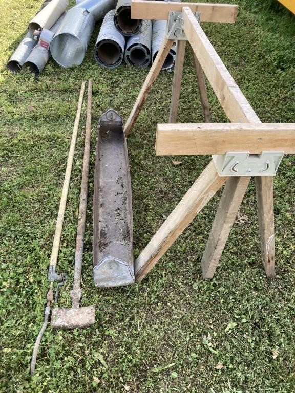 SAWHORSE WITH THE RUSTY METAL TROUGH AND TWO HAND