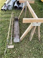 SAWHORSE WITH THE RUSTY METAL TROUGH AND TWO HAND