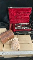 Vintage clarinet in case eight carved wooden