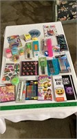 Assorted pens and pencils , notebooks, kids toys,