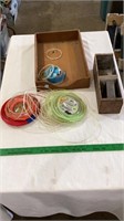 Weed eater string, wooden storage boxes.