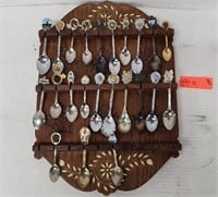 Decorative spoons and wooden wall display.