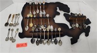 Vintage decorative spoons and wooden wall display.