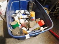 Tub with various spray cans, caulk