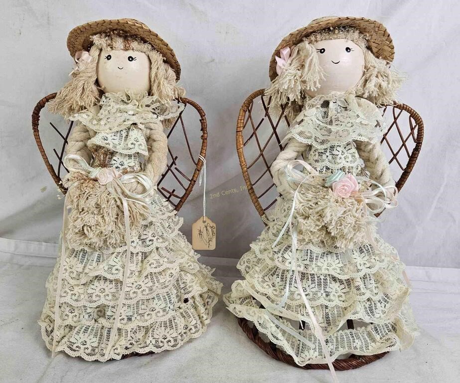 Pair Of Decorative Dolls On Whicker Chairs