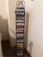 Assorted CDs in Black Metal Tower Rack