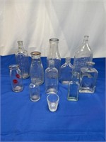 Vintage glass advertising bottles of various