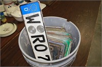 LARGE BUCKET FULL OF OLD LICENSE PLATES
