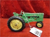 John Deere diecast tractor toy.