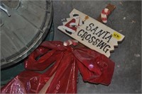 2 christmas tree stands and santa crossing sign
