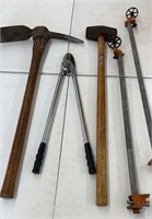 Pickaxe, sledgehammer, loppers, wood clamps