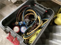Gray/red tote of hoses and gauges