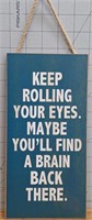 Wooden sign "keep rolling your eyes.maybe you'll