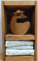 Small wooden shelf with duck and washcloths