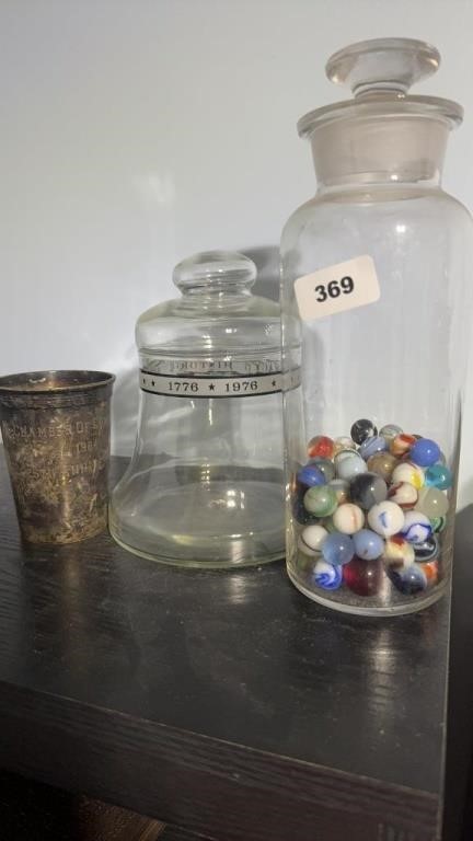 Glass jar of marbles, candy jar, cup