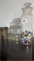 Glass jar of marbles, candy jar, cup