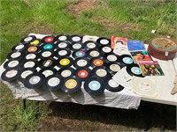 50 assorted genre records/ vinyls with red tin