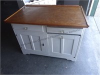 Very old kitchen cabinet with potato bin also has