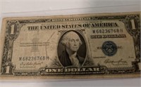 1935E $1 Silver certificate with a protective