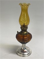 Oil  lamp, measuring 10 inches tall as shown