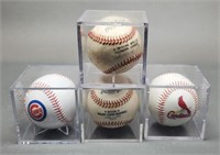 4  Baseballs in Cases