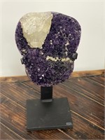 Large amethyst quartz geode specimen on stand