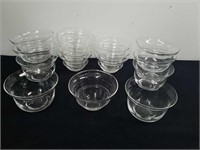 Two sets, eight in each set of glass votive cups