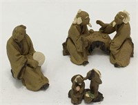 Group Of Miniature Mud Figures