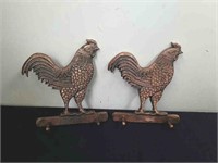 Two metal chicken wall hangers