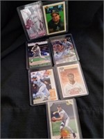 Seven sleeved baseball cards Ripken Jr Rodriguez