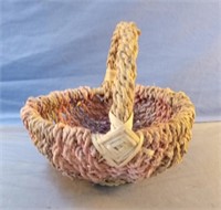 Colorful woven basket with green and pink. Came