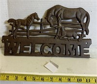 Cast welcome sign