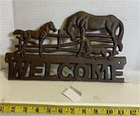 Cast welcome sign