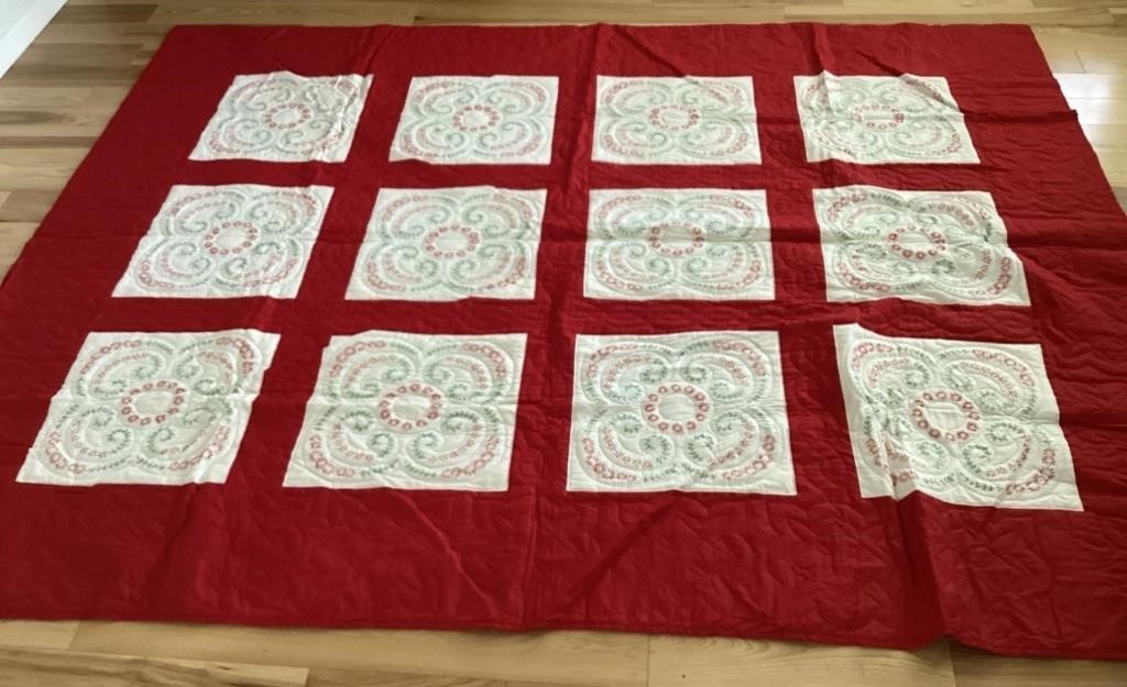 Red and white hand stitched quilt