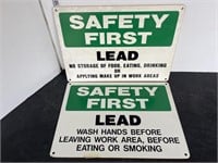 2 plastic safety first signs