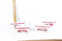 Four toy fire trucks in boxes