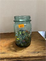 Vintage blue jar with marbles