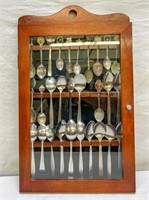 Collection of Travel/Airline Spoons in Display