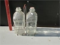 two 1/2 gallon milk bottles in wirey carrier